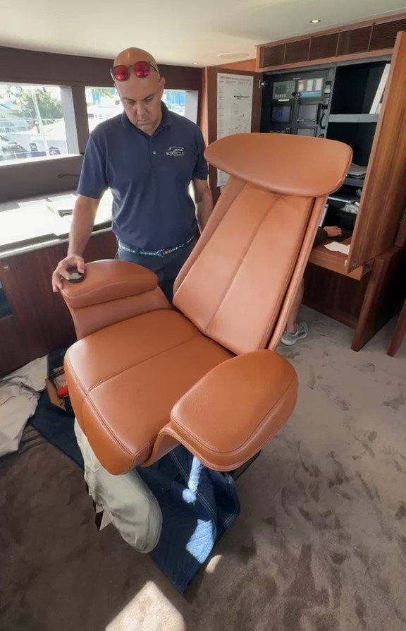 Boatique technician servicing a Besenzoni helm seat on board
