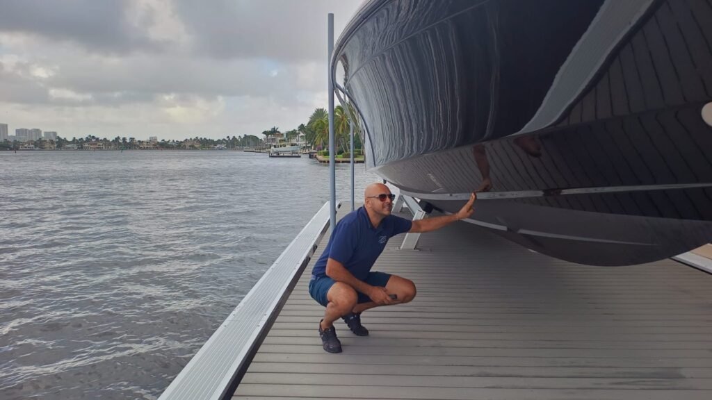 Boatique technician inspecting a yacht hull